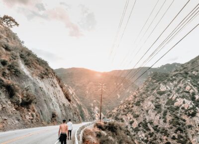 man in black shorts walking on gray road